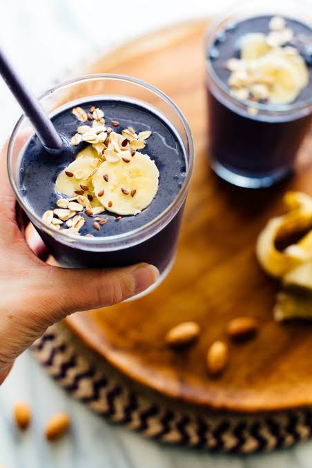 Dark blueberry banana smoothie topped with oats