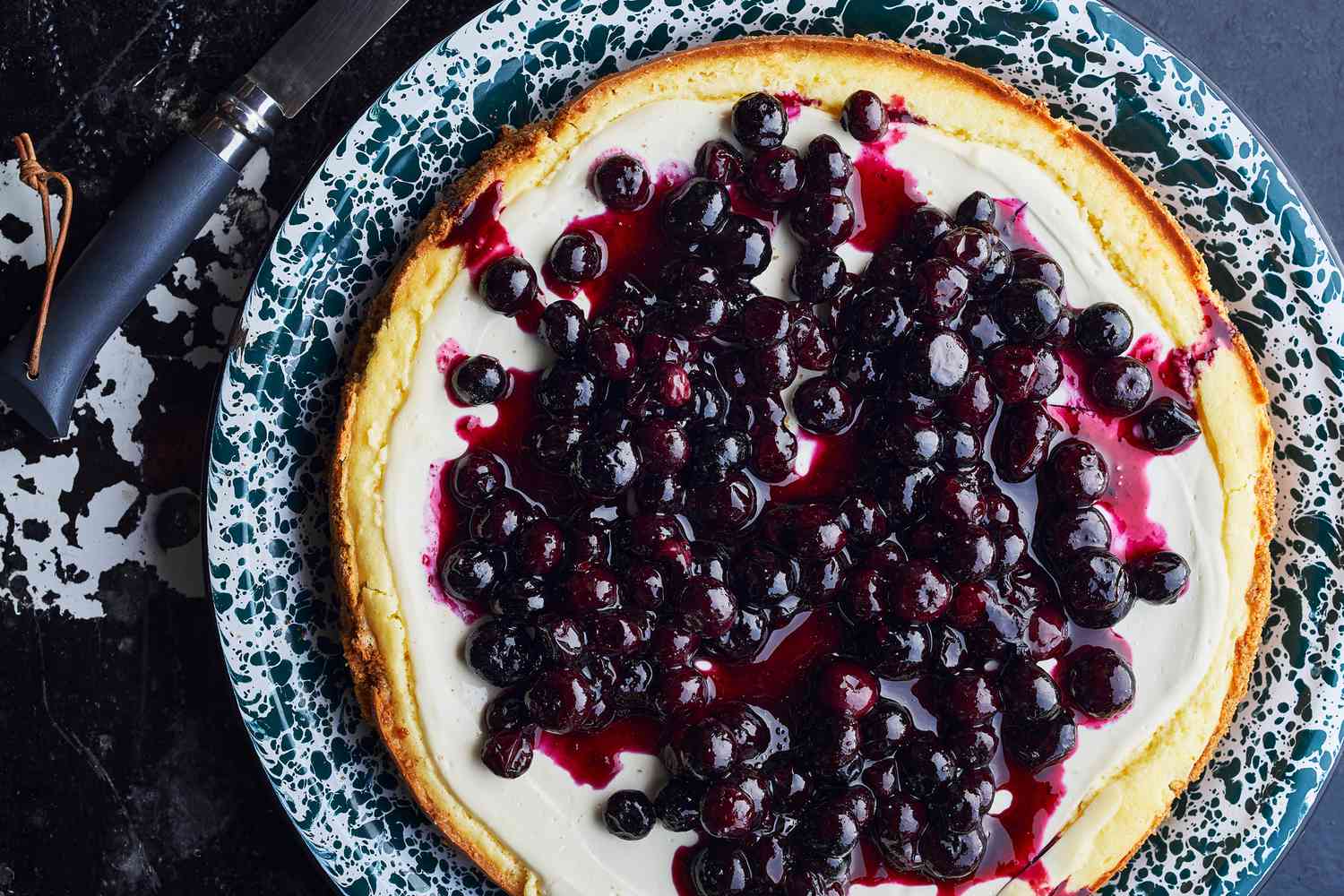 Baked cheesecake topped with glossy blueberries