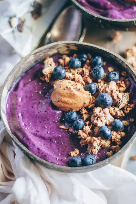 Blueberry power bowl with granola and a spoonful of nut butter